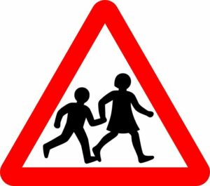 children in road ahead sign